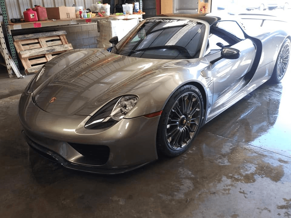 Silver Porsche sports car in a professional detailing garage
